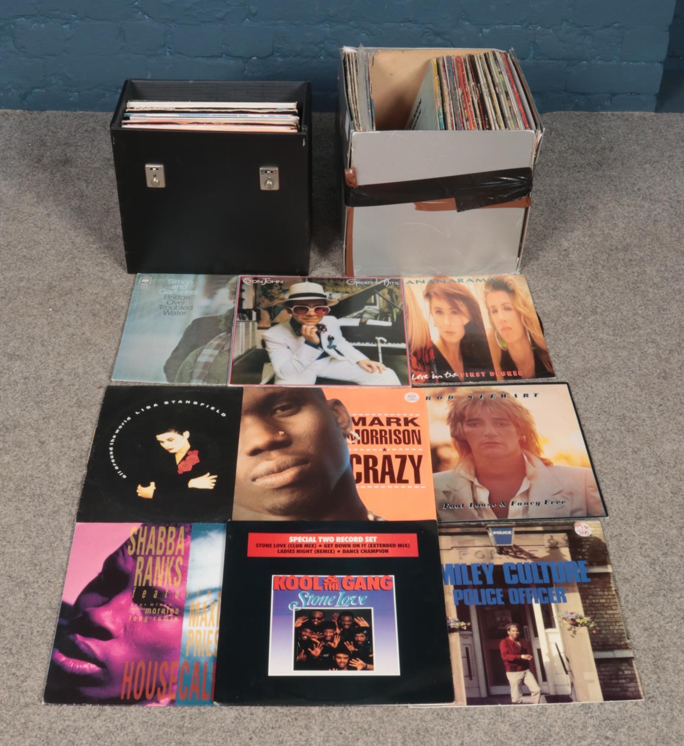 A large box and carry case of Rock, Pop and Reggae single and album vinyl records. To include