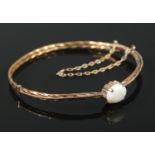 A 9ct gold rope twist opal bangle. 5.28g.