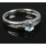 A 9ct white gold aquamarine & diamond ring. Size K. 2g.