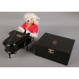 A small Steiff bear formed as Mozart along with a miniature musical Wolfgang & Mozart piano and box.