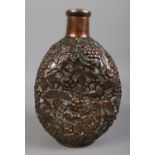 A glass dimple form decanter overlaid with white metal. Decorated with berries, leaves and