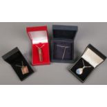 Four boxed silver pendants on chains. Includes paste set, penny red example, enamelled etc.