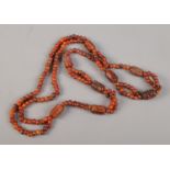 A double string amber/copal necklace with carved beads.