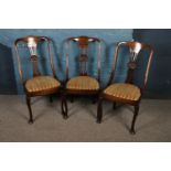 Three matching Victorian carved mahogany dining chairs.