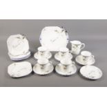 An Art Deco 'Shelley' Vincent shape part tea set. Five cups, six saucers, serving plate, side plates