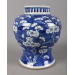 A 19th Century Chinese ginger jar, decorated with prunus blossom in blue and white. Four character