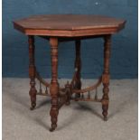 An oak octagonal window table, with spindle stretcher. Raised on casters. Height: 72cm, Width: 74cm,