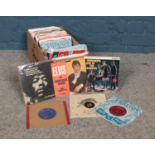 A box of 1960's 45rpm vinyl records. Artists to include The Rolling Stones, The Beatles, The Who,