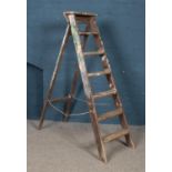 A large set of wooden step ladders.