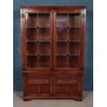 An Old Charm carved oak lead glazed cabinet with cupboard base.
