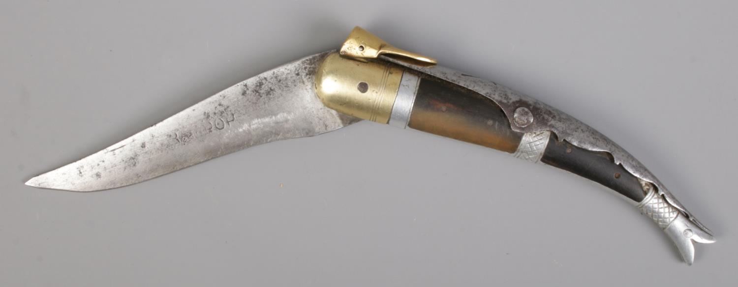 An early 20th century folding knife. With antler handle and white metal mounts. Possibly Indian.