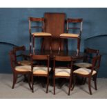 A mahogany twin pedestal table and set of eight chairs.