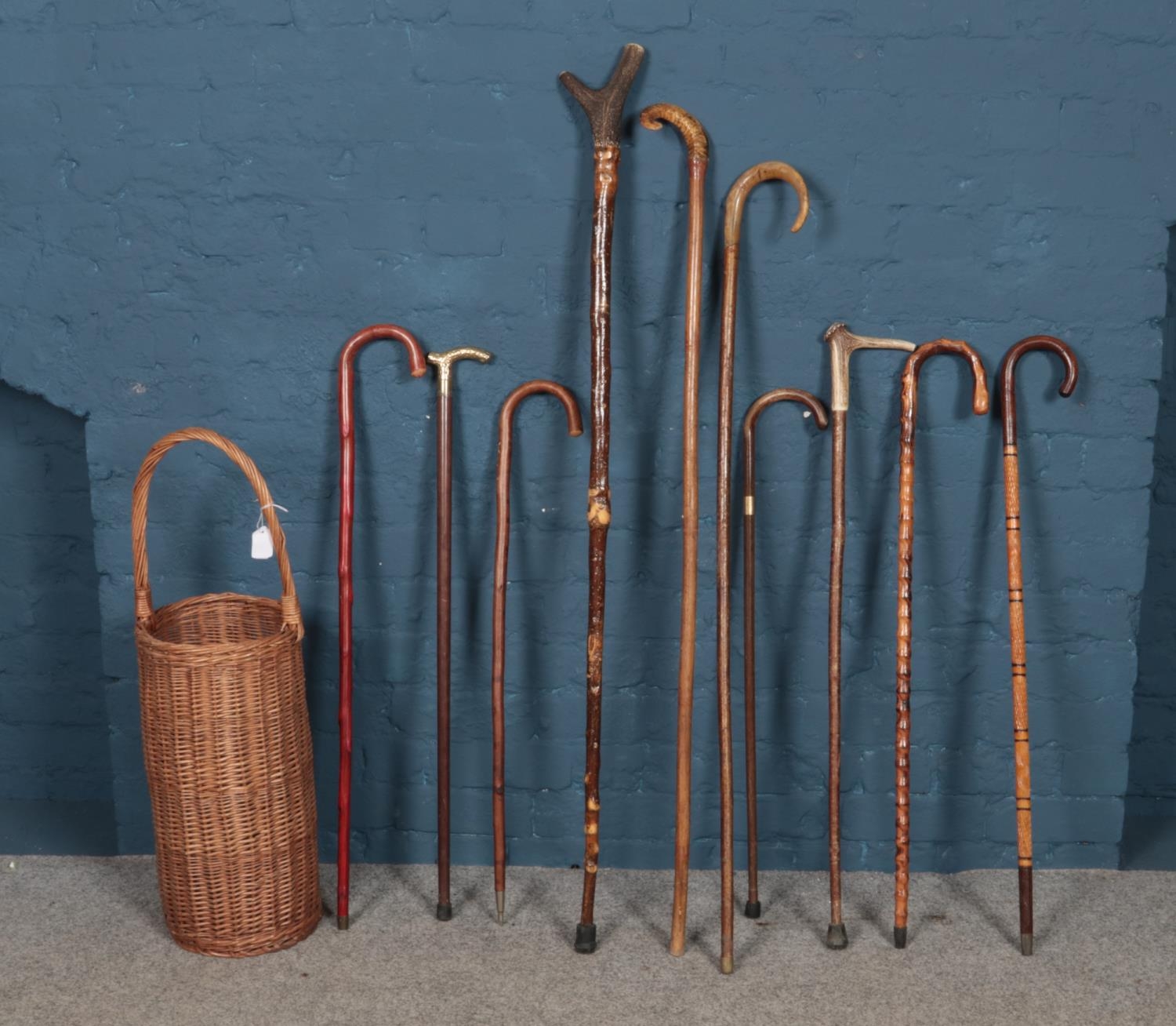 Ten walking sticks with wicker basket. Four sticks with antlers as handles. Tallest: H:137cm.