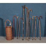 Ten walking sticks with wicker basket. Four sticks with antlers as handles. Tallest: H:137cm.