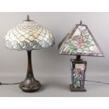 Two tiffany style table lamps with lead glazed shades, decorated with roses and waves. Minor