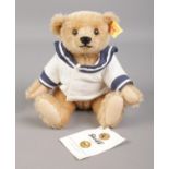A Steiff 'sailor' bear, seated, with gold button to ear and original tag. 16cm high.