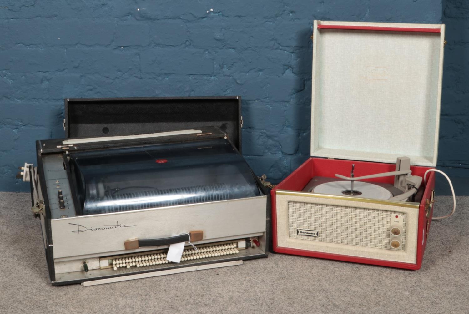 A 1960's Discomatic portable jukebox & Dansette Monarch portable record player. Will both need