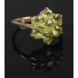 A 9ct gold peridot cluster ring. Size P. 3.78g.