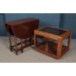 An oak barley twist drop leaf table along with a glass top coffee table.