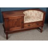 An oak telephone table. With drawer and cupboard to one side. (71cm x 123cm)