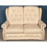 A cream leather buttoned three piece suite by Centurion Furniture The Chesterfield Specialists along