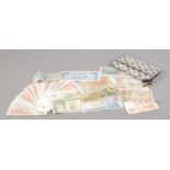 A ladies purse containing a collection of foreign bank notes, including Peru Intis, Barbados dollars