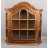 An oak hanging wall cabinet. Height: 69cm, Width: 65cm.