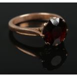 A 9ct gold garnet solitaire ring. Size N. 3.75g.