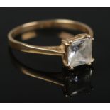 A 9ct gold ring set with a single square clear coloured stone. Size Q 1/2. 2.06g.