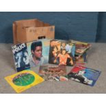 A box of assorted 12" vinyl records. Artists to include Paul McCartney, Odyssey, Simon &