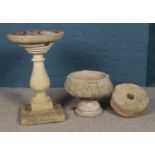 A three piece garden birdbath, together with a grindstone and garden planter. Height of birdbath: