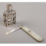 An early 20th century mother of pearl and silver fruit knife, along with a silver mounted glass