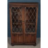A Priory oak bookcase with lead glazed glass panel doors. (133cm x 81cm)