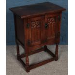 A small carved oak side cabinet. (68cm x 51cm)
