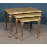A nest of three tables. With onyx tops and gilt metal frames. H: 43cm W: 60cm D: 36cm.