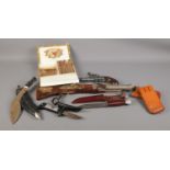 An assortment of miscellaneous. To include two replica pistols, a "Okapi" sheath knife, and a