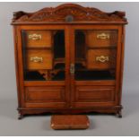 An oak smokers cabinet with bevelled glass panel doors along with a Bayley & Holdsworth pipe case.