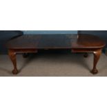 A Victorian carved mahogany wind out dining table. With two extra leaves. Raised on carved ball