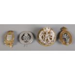 Four assorted military badges, to include 'For King and Empire, Service Rendered' and 'Royal Corps