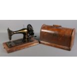 A oak cased hand crank Singer sewing machine.