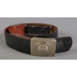 A German leather belt with Einigkeit Recht Freiheit buckle.