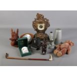 A box of miscellaneous. Includes riding crop, clocks, carved wooden dragon figure etc.