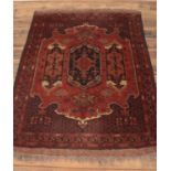 An Afghan wool rug. With red ground and central trio design. (Bakhshayesh)153 x 102cm.