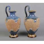 A pair of Royal Doulton Lambeth Ewers. H: 24cm. Stamped to the base and numbered 5290.