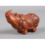 A Chinese carved boxwood figure of a rhino. Height 4cm, Length 7cm.