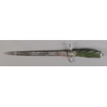 An antique double edged dagger with white metal hilt and pommel and twisted green grip. Length 33cm.