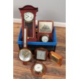 A box of assorted clocks and barometers.