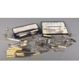 A box of assorted metalwares. To include boxed fish serving cutlery, knives, spoons and knife
