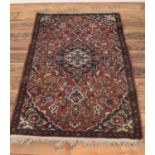 A Keshan rug. With central medallion design on a blue and light brown ground. 137 x 82cm.