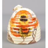 A Wilkinson Ltd Clarice Cliff beehive honey pot decorated in the Rhodanthe design. 10cm.
